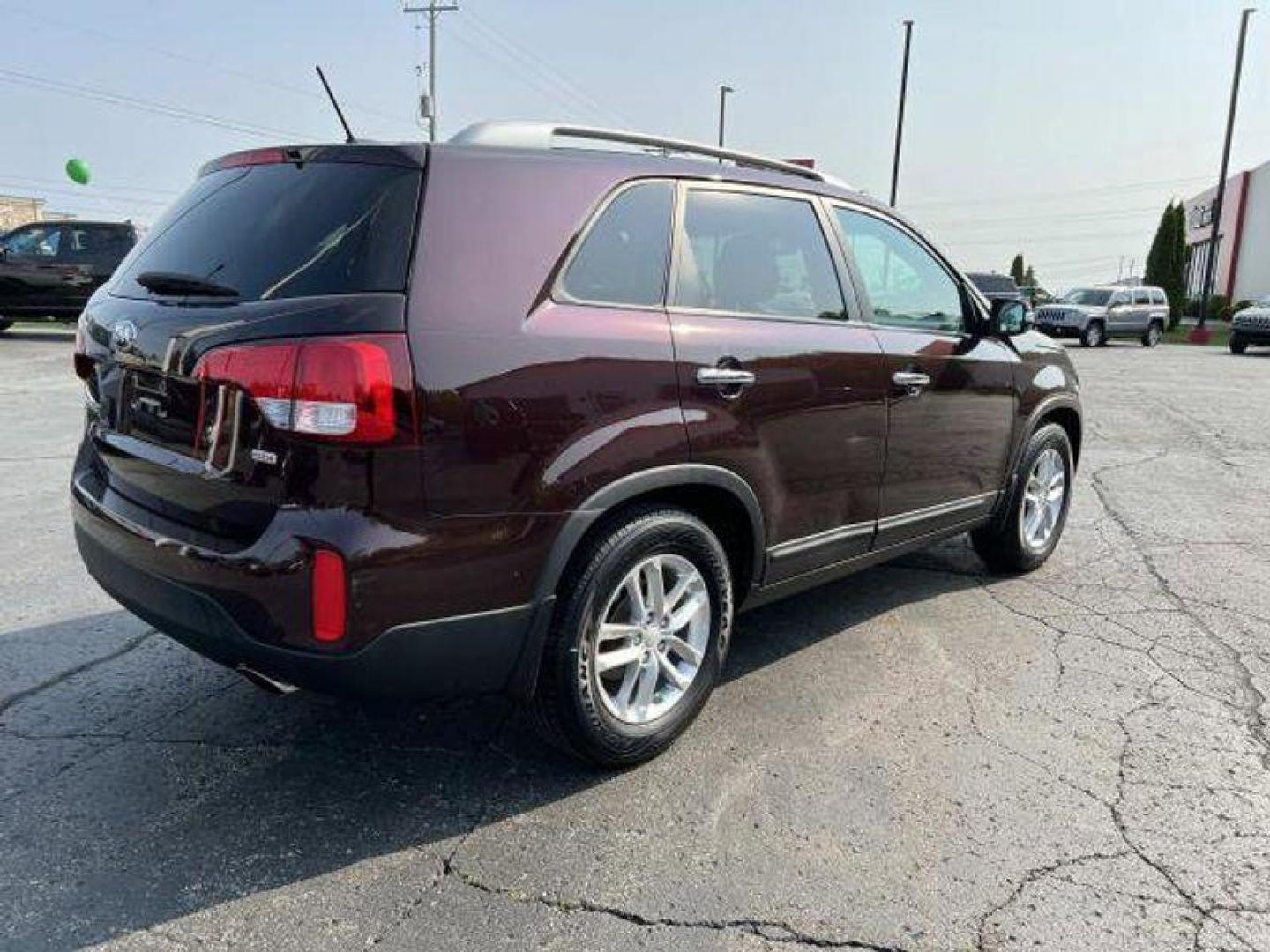 2015 Dark Cherry /Black Kia Sorento LX V6 FWD (5XYKT4A73FG) with an 3.3L V6 DOHC 24V engine, 6-Speed Automatic transmission, located at 6064 Gull Rd, Kalamazoo, MI, 49048, (269) 222-0088, 42.328388, -85.512924 - <b>Vehicle Details</b><br>Introducing the exceptional 2015 Kia Sorento LX, a remarkable SUV that combines versatility, reliability, and style. With only one previous owner and a clean CARFAX report, this vehicle is the epitome of dependability. Boasting a stunning exterior finished in a sleek and ti - Photo#4