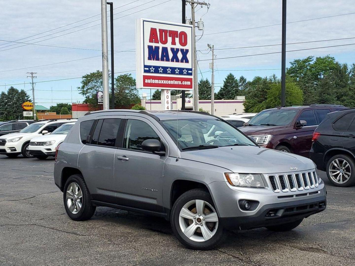 2016 Billet Silver Metallic Clearcoat /Dark Slate Gray Jeep Compass Sport 4WD (1C4NJDBBXGD) with an 2.4L L4 DOHC 16V engine, 6-speed automatic transmission, located at 6064 Gull Rd, Kalamazoo, MI, 49048, (269) 222-0088, 42.328388, -85.512924 - <b>Vehicle Details</b><br>Discover the thrill of adventure with our stunning 2016 Jeep Compass Sport! This bold and dynamic SUV is ready to tackle any terrain, thanks to its robust 4WD system and powerful L4, 2.4L engine. Whether you're navigating city streets or exploring off-road trails, the Compa - Photo#0