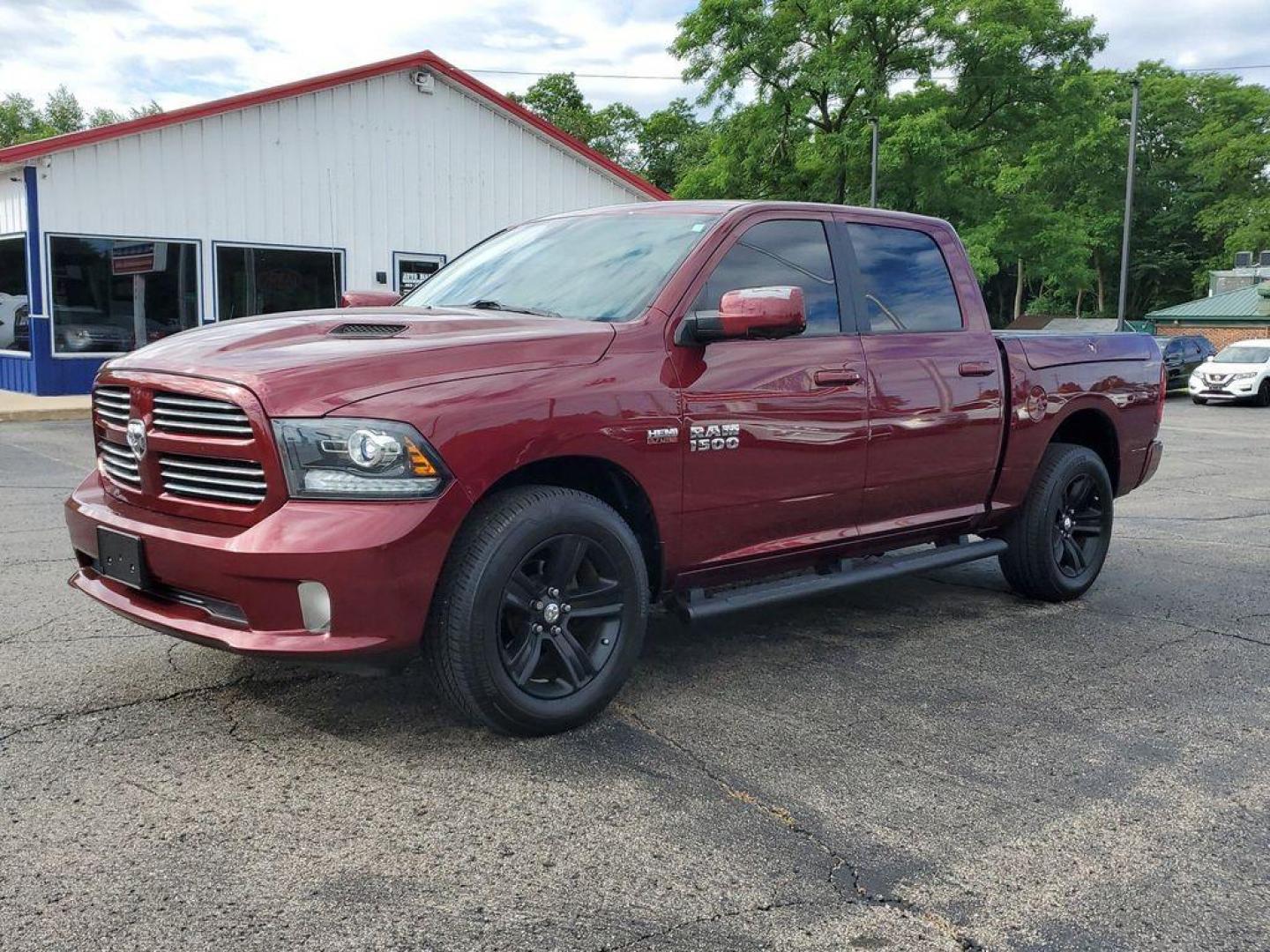 2017 Red Pearl /Black RAM 1500 Sport Crew Cab SWB 4WD (1C6RR7MT0HS) with an 5.7L V8 OHV 16V engine, 8A transmission, located at 6064 Gull Rd, Kalamazoo, MI, 49048, (269) 222-0088, 42.328388, -85.512924 - <b>Vehicle Details</b><br>Introducing the 2017 Ram 1500 Sport, a robust and versatile pickup designed to meet the demands of both work and play. This 4WD powerhouse is equipped with a formidable 5.7L V8 engine, delivering impressive performance and reliability. The Ram 1500 Sport seamlessly blends s - Photo#1