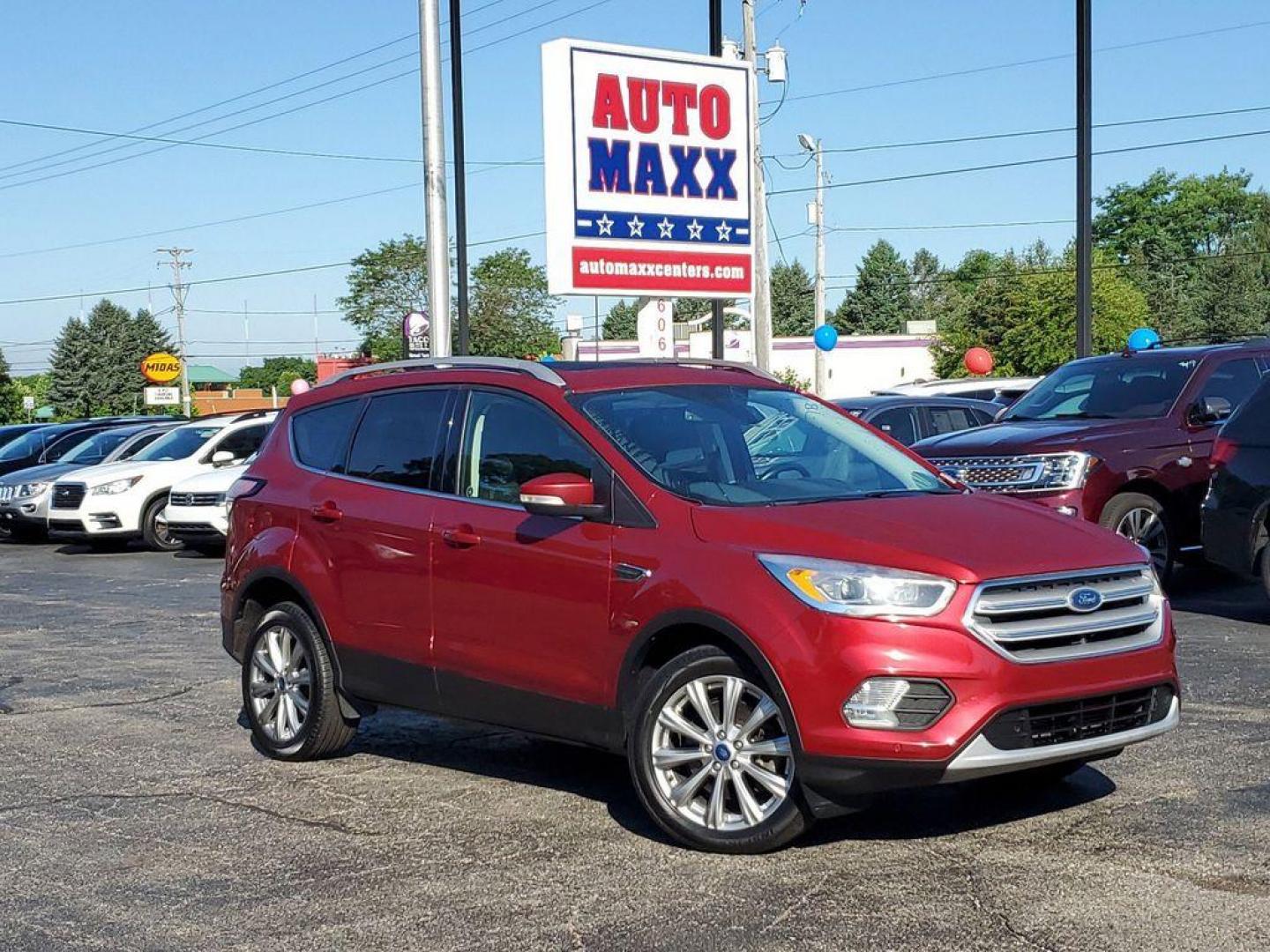 2018 Ruby Red Metallic Tinted Clearcoat /Charcoal Black Ford Escape Titanium 4WD (1FMCU9J94JU) with an 2.0L L4 DOHC 16V engine, 6A transmission, located at 234 Columbia Ave, Battle Creek, MI, 49015, (269) 222-0088, 42.298264, -85.192543 - <b>Vehicle Details</b><br>Looking for a reliable and feature-packed SUV? Check out this 2018 Ford Escape Titanium with 4WD, now available at our dealership. This vehicle is equipped with a powerful L4, 2.0L engine, making it perfect for both city driving and off-road adventures. The interior of thi - Photo#0