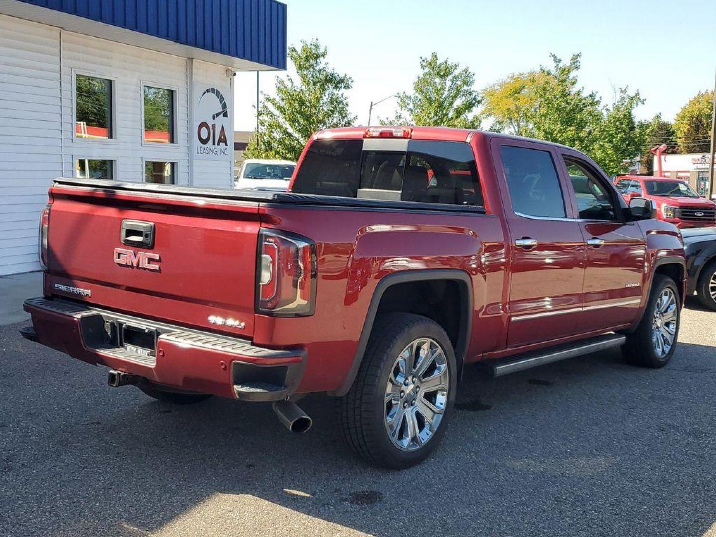 2018 Red Quartz Tintcoat /Jet Black GMC Sierra 1500 Denali Crew Cab Long Box 4WD (3GTU2PEJ9JG) with an 6.2L V8 OHV 16V engine, 6A transmission, located at 234 Columbia Ave, Battle Creek, MI, 49015, (269) 222-0088, 42.298264, -85.192543 - <b>Vehicle Details</b><br>Discover the power and luxury of the 2018 GMC Sierra 1500 Denali at our dealership. This pre-owned gem comes equipped with a robust V8, 6.2L engine and 4WD, ensuring you have the muscle and traction needed for any adventure or tough job. Step inside to experience true com - Photo#1