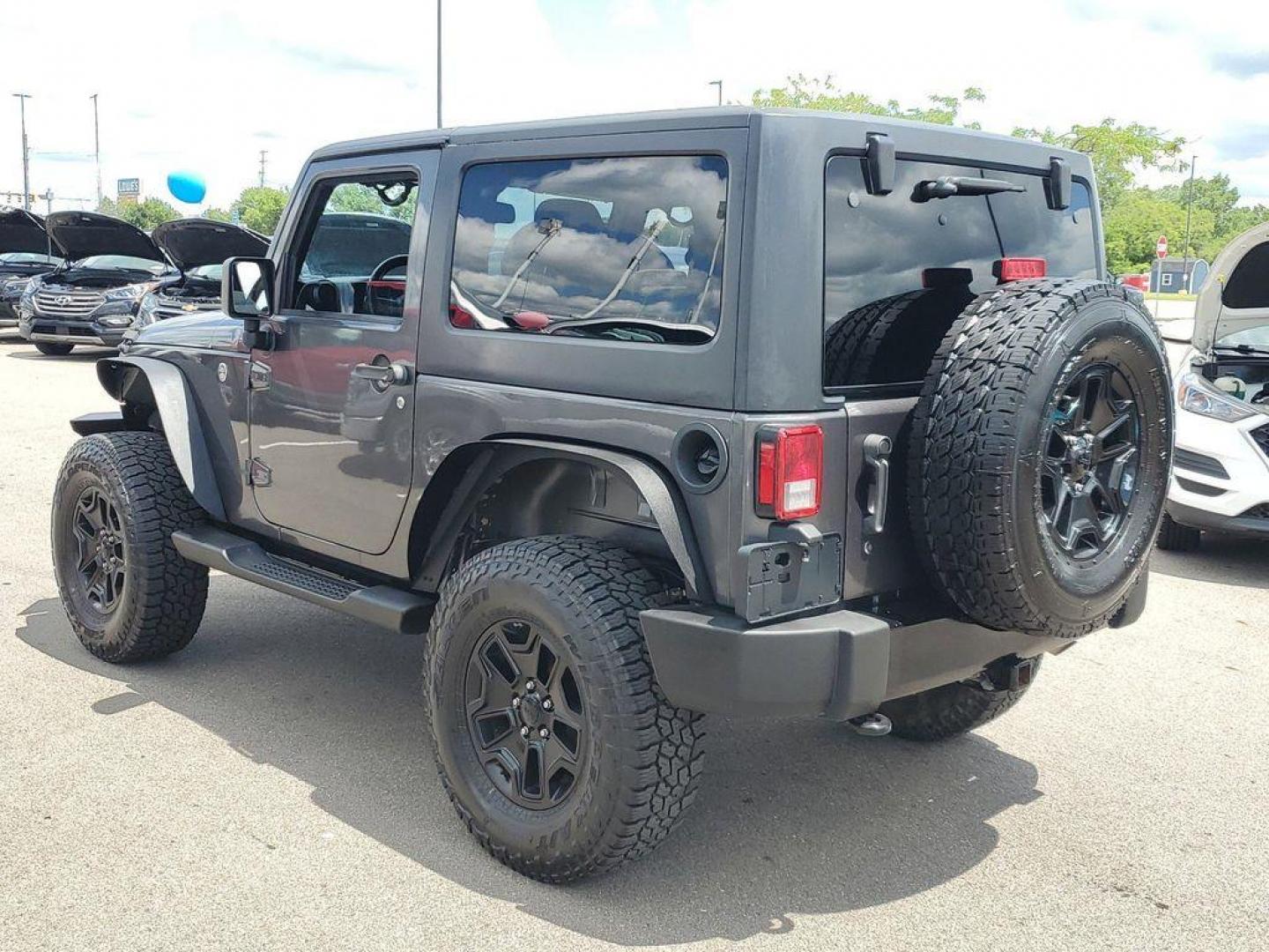 2018 Granite Crystal Metallic Clearcoat /Black Jeep Wrangler Sport 4WD (1C4AJWAG0JL) with an 3.6L V6 DOHC 24V FFV engine, 5-speed automatic transmission, located at 234 Columbia Ave, Battle Creek, MI, 49015, (269) 222-0088, 42.298264, -85.192543 - Discover the epitome of rugged capability with this 2018 Jeep Wrangler JK Willys Wheeler W, now available at our dealership. This iconic 4WD off-road vehicle is powered by a robust 3.6L V6 engine, delivering a perfect blend of performance and reliability for any adventure. With its distinctive Willy - Photo#2