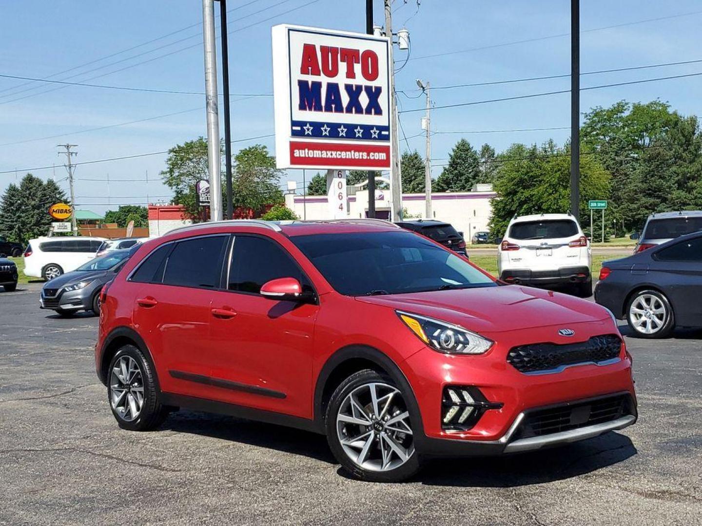 2021 Runway Red /Charcoal Kia Niro Touring (KNDCC3LC9M5) with an 1.6L L4 DOHC 16V HYBRID engine, 6A transmission, located at 6064 Gull Rd, Kalamazoo, MI, 49048, (269) 222-0088, 42.328388, -85.512924 - Experience the perfect blend of efficiency, style, and modern technology with this stunning 2021 Kia Niro Touring! This impressive vehicle is designed to make every drive an exhilarating adventure, combining the versatility of a crossover with the fuel efficiency of a hybrid.<br><br>The Niro Touring - Photo#0