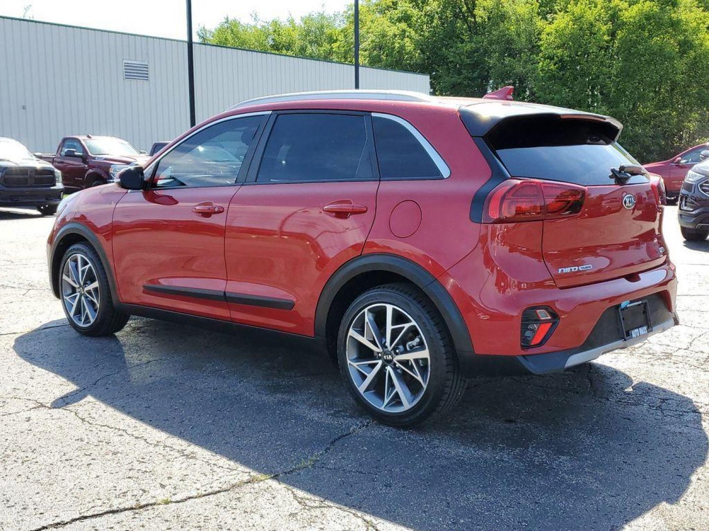 2021 Runway Red /Charcoal Kia Niro Touring (KNDCC3LC9M5) with an 1.6L L4 DOHC 16V HYBRID engine, 6A transmission, located at 6064 Gull Rd, Kalamazoo, MI, 49048, (269) 222-0088, 42.328388, -85.512924 - Experience the perfect blend of efficiency, style, and modern technology with this stunning 2021 Kia Niro Touring! This impressive vehicle is designed to make every drive an exhilarating adventure, combining the versatility of a crossover with the fuel efficiency of a hybrid.<br><br>The Niro Touring - Photo#2