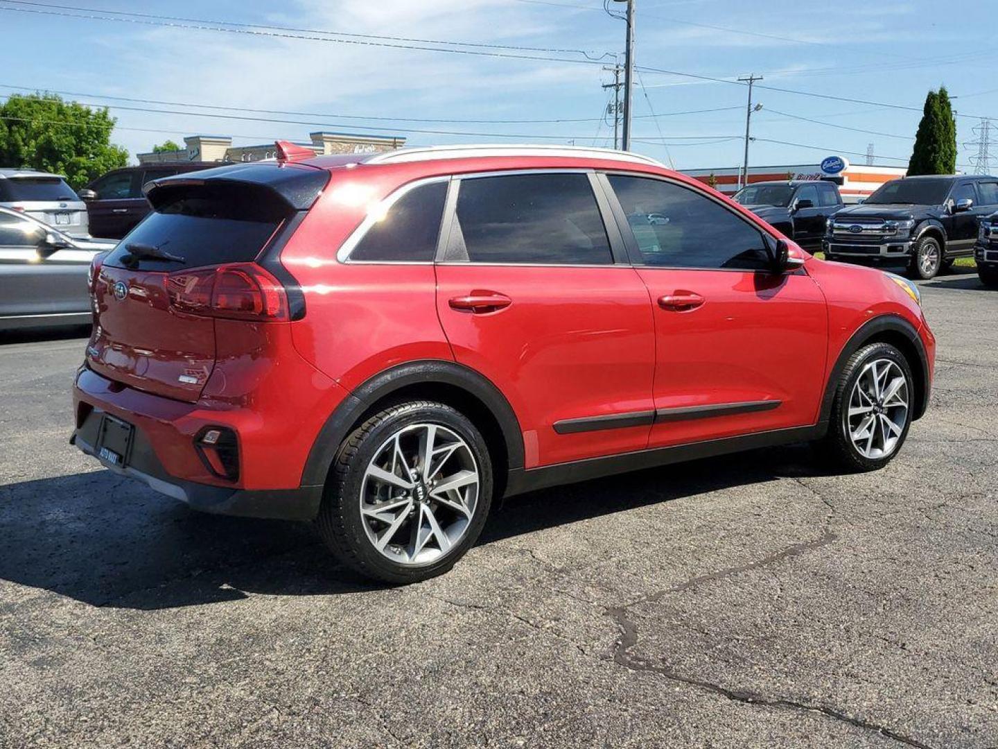 2021 Runway Red /Charcoal Kia Niro Touring (KNDCC3LC9M5) with an 1.6L L4 DOHC 16V HYBRID engine, 6A transmission, located at 6064 Gull Rd, Kalamazoo, MI, 49048, (269) 222-0088, 42.328388, -85.512924 - Experience the perfect blend of efficiency, style, and modern technology with this stunning 2021 Kia Niro Touring! This impressive vehicle is designed to make every drive an exhilarating adventure, combining the versatility of a crossover with the fuel efficiency of a hybrid.<br><br>The Niro Touring - Photo#3