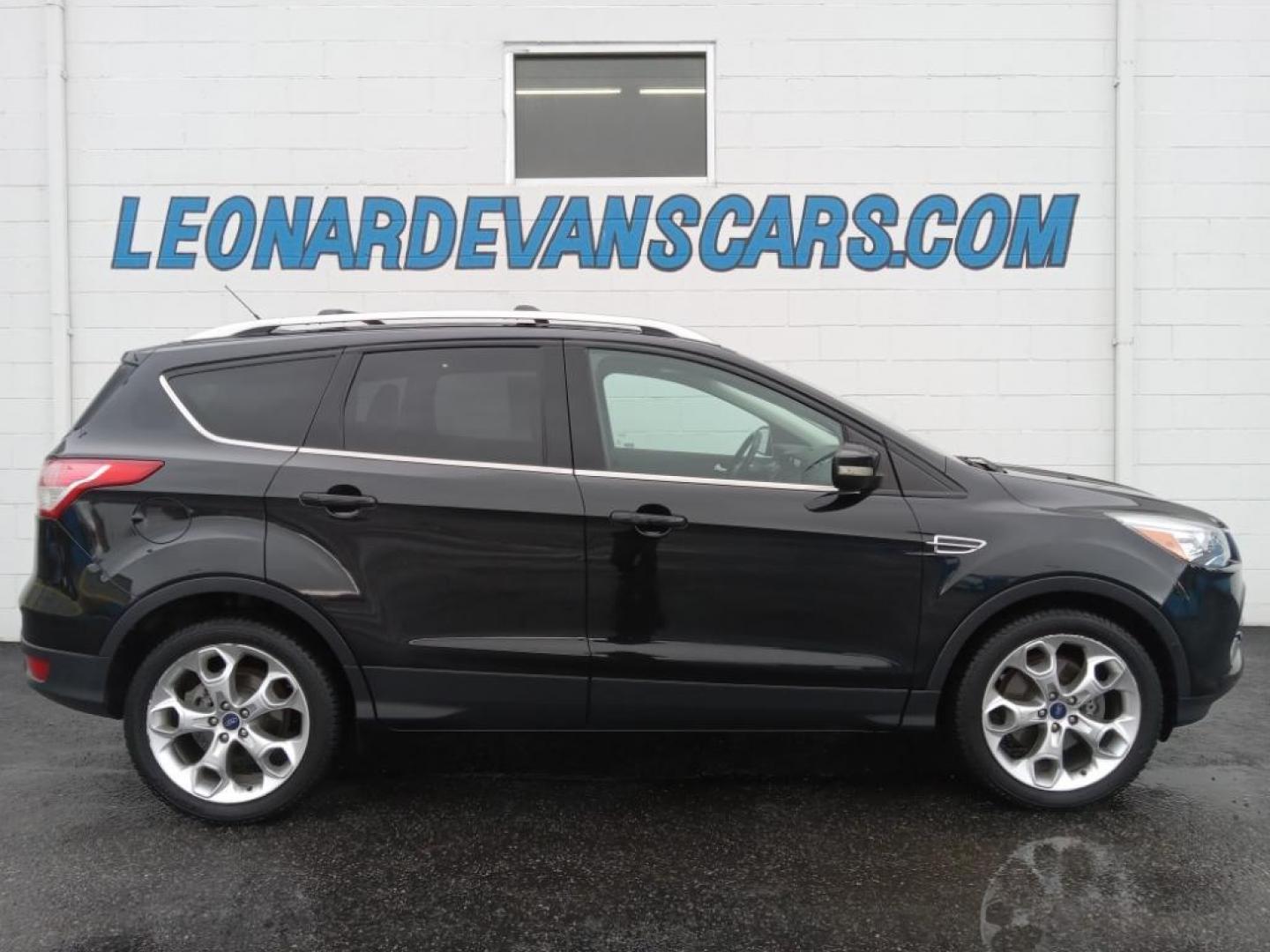 2015 BLACK /Charcoal Black Ford Escape Titanium 4WD (1FMCU9J93FU) with an 2.0L L4 DOHC 16V engine, 6-Speed Automatic transmission, located at 6064 Gull Rd, Kalamazoo, MI, 49048, (269) 222-0088, 42.328388, -85.512924 - <b>Equipment</b><br>The leather seats in the vehicle are a must for buyers looking for comfort, durability, and style. The vehicle keeps you comfortable with Auto Climate. See what's behind you with the back up camera on it. The Ford Escape will allow to see the road and so much more with the HID he - Photo#0