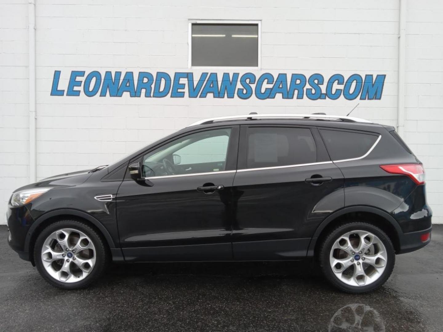 2015 BLACK /Charcoal Black Ford Escape Titanium 4WD (1FMCU9J93FU) with an 2.0L L4 DOHC 16V engine, 6-Speed Automatic transmission, located at 6064 Gull Rd, Kalamazoo, MI, 49048, (269) 222-0088, 42.328388, -85.512924 - <b>Equipment</b><br>The leather seats in the vehicle are a must for buyers looking for comfort, durability, and style. The vehicle keeps you comfortable with Auto Climate. See what's behind you with the back up camera on it. The Ford Escape will allow to see the road and so much more with the HID he - Photo#1