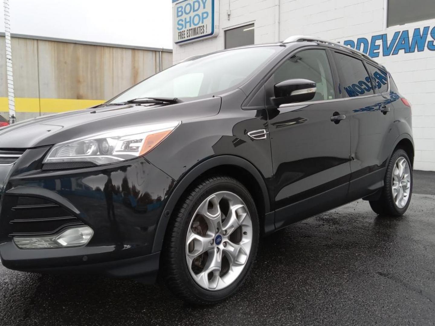 2015 BLACK /Charcoal Black Ford Escape Titanium 4WD (1FMCU9J93FU) with an 2.0L L4 DOHC 16V engine, 6-Speed Automatic transmission, located at 6064 Gull Rd, Kalamazoo, MI, 49048, (269) 222-0088, 42.328388, -85.512924 - <b>Equipment</b><br>The leather seats in the vehicle are a must for buyers looking for comfort, durability, and style. The vehicle keeps you comfortable with Auto Climate. See what's behind you with the back up camera on it. The Ford Escape will allow to see the road and so much more with the HID he - Photo#2