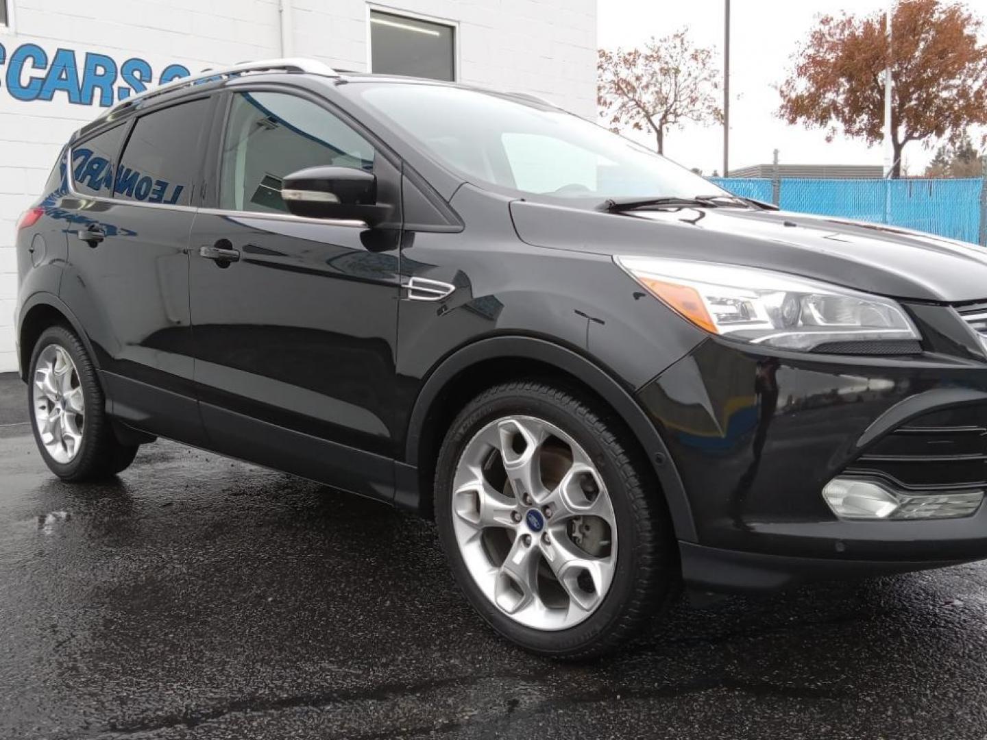 2015 BLACK /Charcoal Black Ford Escape Titanium 4WD (1FMCU9J93FU) with an 2.0L L4 DOHC 16V engine, 6-Speed Automatic transmission, located at 6064 Gull Rd, Kalamazoo, MI, 49048, (269) 222-0088, 42.328388, -85.512924 - <b>Equipment</b><br>The leather seats in the vehicle are a must for buyers looking for comfort, durability, and style. The vehicle keeps you comfortable with Auto Climate. See what's behind you with the back up camera on it. The Ford Escape will allow to see the road and so much more with the HID he - Photo#4