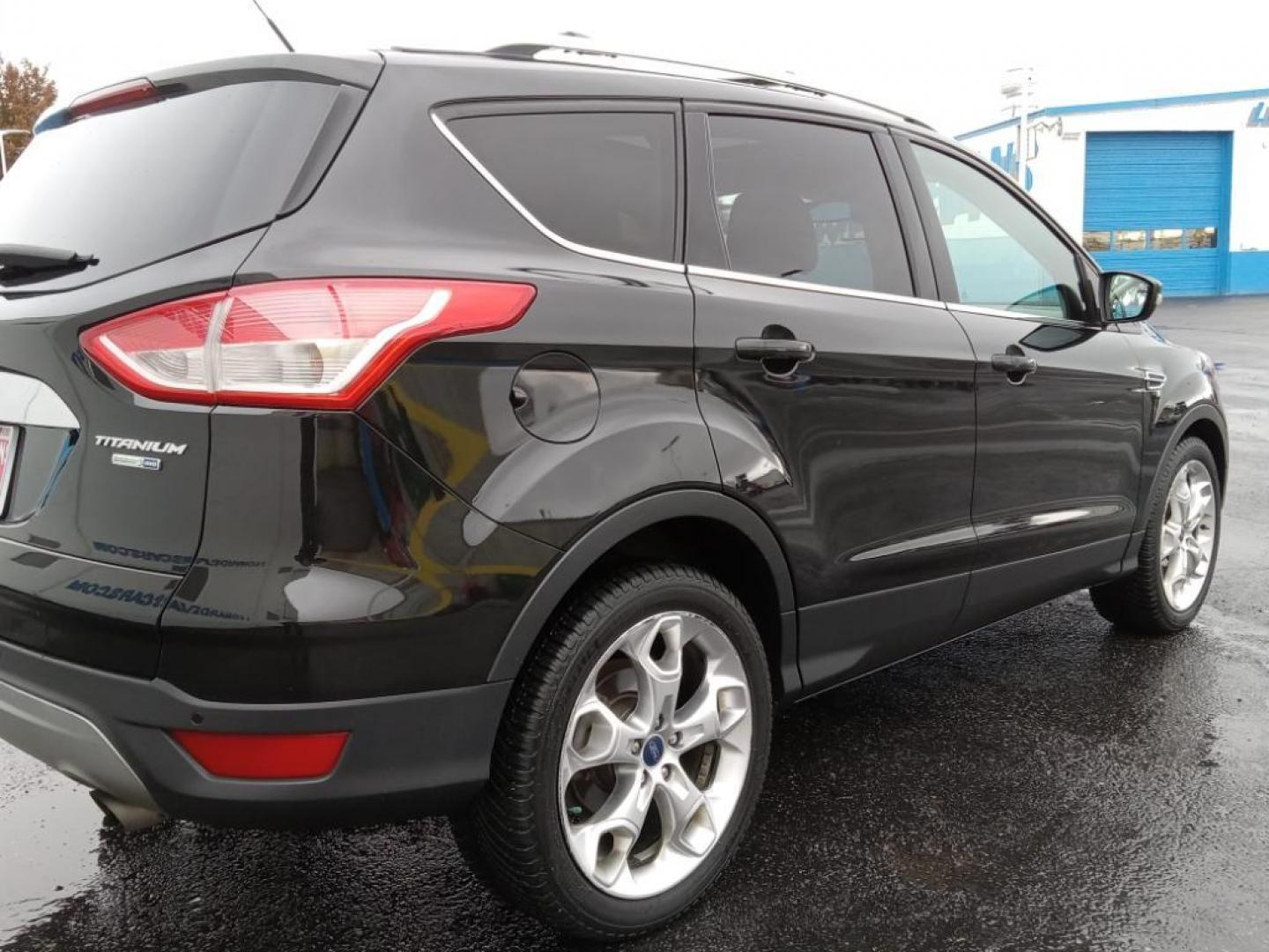 2015 BLACK /Charcoal Black Ford Escape Titanium 4WD (1FMCU9J93FU) with an 2.0L L4 DOHC 16V engine, 6-Speed Automatic transmission, located at 6064 Gull Rd, Kalamazoo, MI, 49048, (269) 222-0088, 42.328388, -85.512924 - <b>Equipment</b><br>The leather seats in the vehicle are a must for buyers looking for comfort, durability, and style. The vehicle keeps you comfortable with Auto Climate. See what's behind you with the back up camera on it. The Ford Escape will allow to see the road and so much more with the HID he - Photo#5