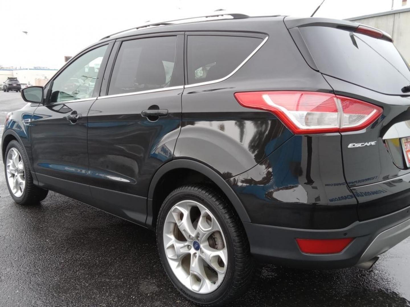 2015 BLACK /Charcoal Black Ford Escape Titanium 4WD (1FMCU9J93FU) with an 2.0L L4 DOHC 16V engine, 6-Speed Automatic transmission, located at 6064 Gull Rd, Kalamazoo, MI, 49048, (269) 222-0088, 42.328388, -85.512924 - <b>Equipment</b><br>The leather seats in the vehicle are a must for buyers looking for comfort, durability, and style. The vehicle keeps you comfortable with Auto Climate. See what's behind you with the back up camera on it. The Ford Escape will allow to see the road and so much more with the HID he - Photo#7