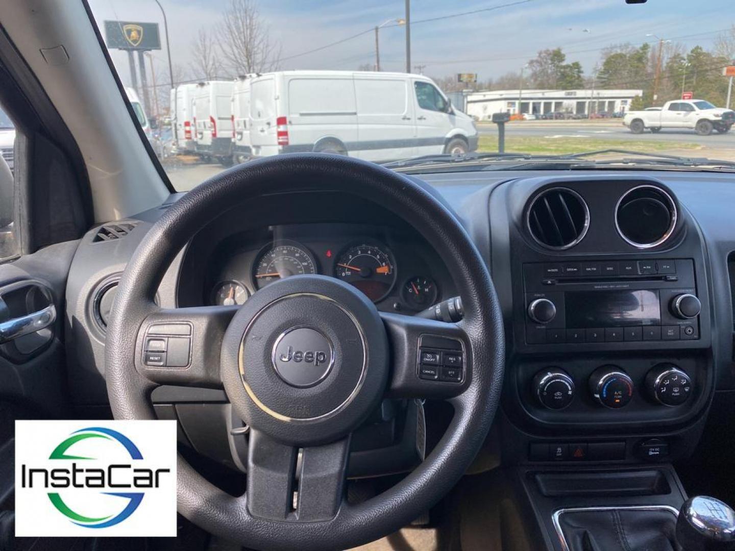 2014 Black Clearcoat /Dark Slate Gray Jeep Compass Sport FWD (1C4NJCBA9ED) with an 2.0L L4 DOHC 16V engine, 5-speed manual transmission, located at 6064 Gull Rd, Kalamazoo, MI, 49048, (269) 222-0088, 42.328388, -85.512924 - Introducing the impeccable 2014 Jeep Compass Sport, now available at our esteemed dealership. This used gem has been meticulously maintained and is ready to embark on its next adventure with you. With a remarkable mileage of 179,461 miles, this SUV has proven its reliability and longevity, making it - Photo#2