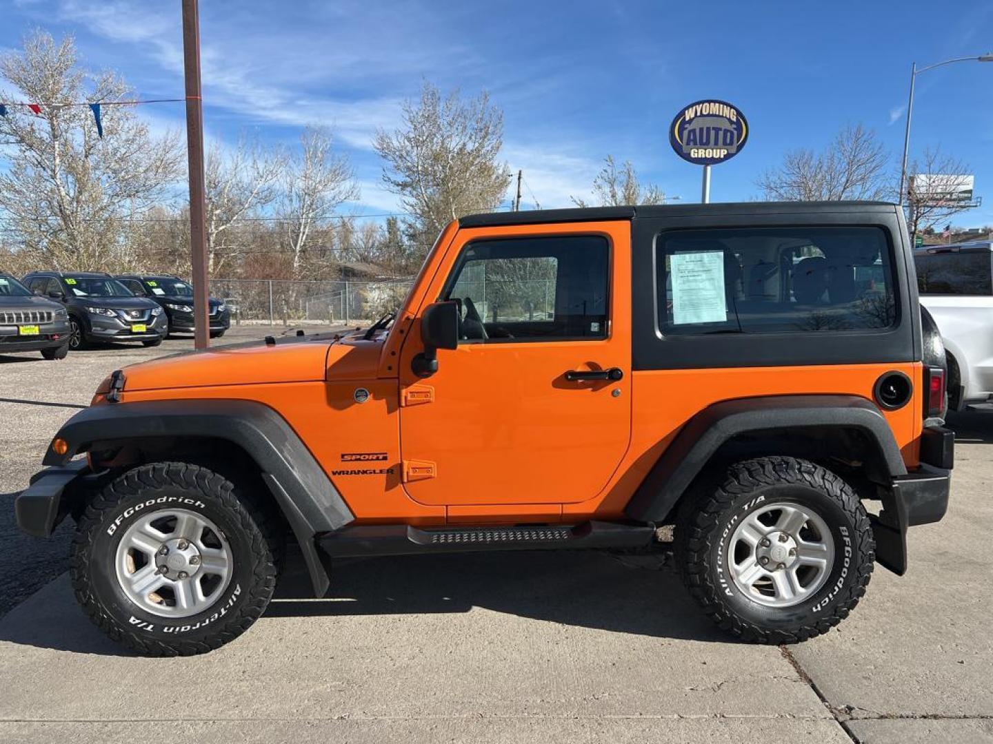 2012 orange Jeep Wrangler Sport 4WD (1C4AJWAG7CL) with an 3.6L V6 DOHC 24V FFV engine, Automatic transmission, located at 6064 Gull Rd, Kalamazoo, MI, 49048, (269) 222-0088, 42.328388, -85.512924 - Photo#0